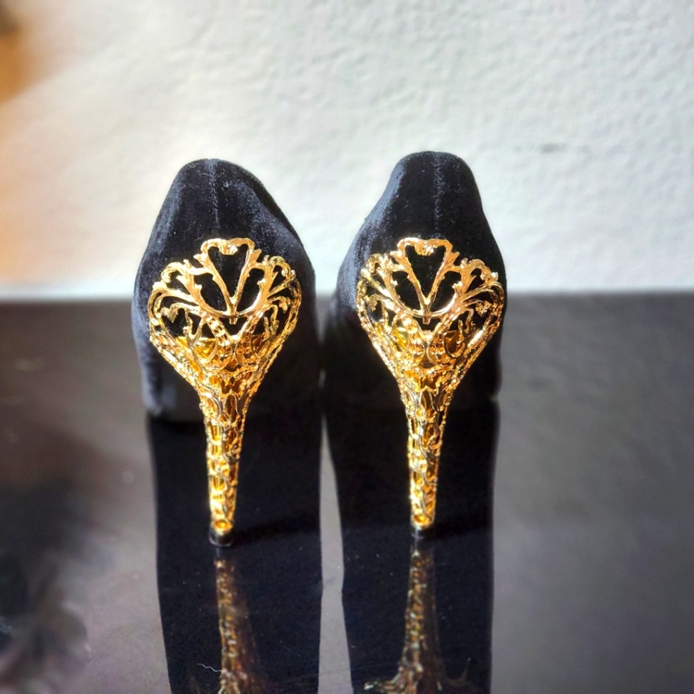 New with box worn once. Black velvet with gold design heels. Size 9 wide